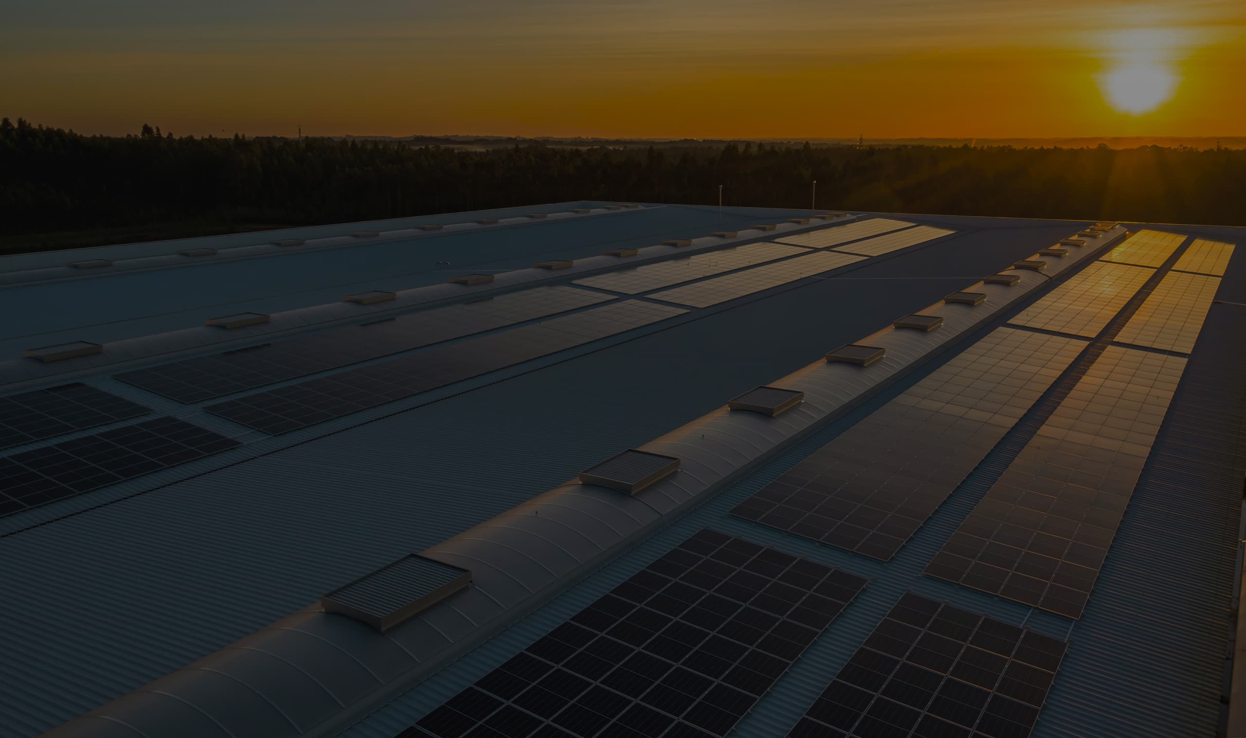 Dramatic view of a sunset, with light refracting off of solar panels