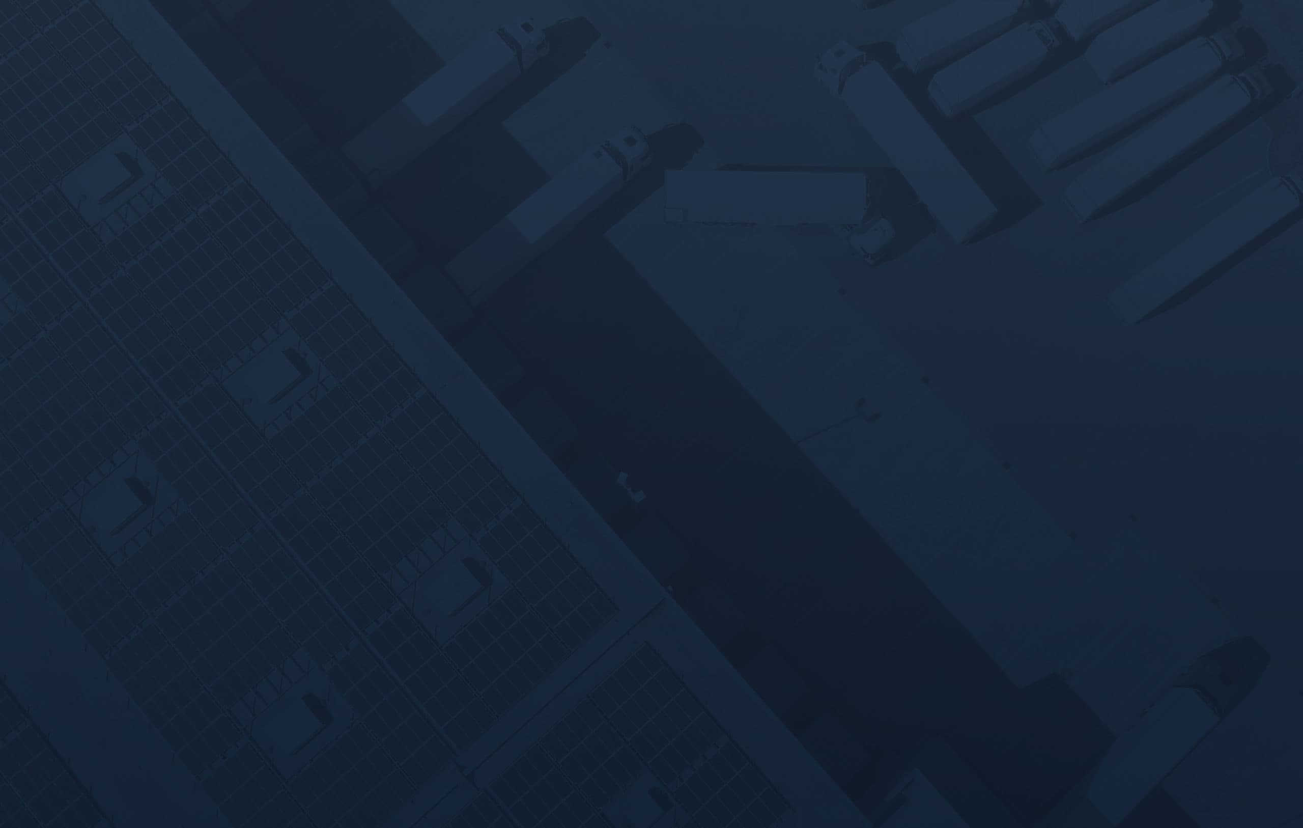 A grid-like overhead view of warehouses with solar panels