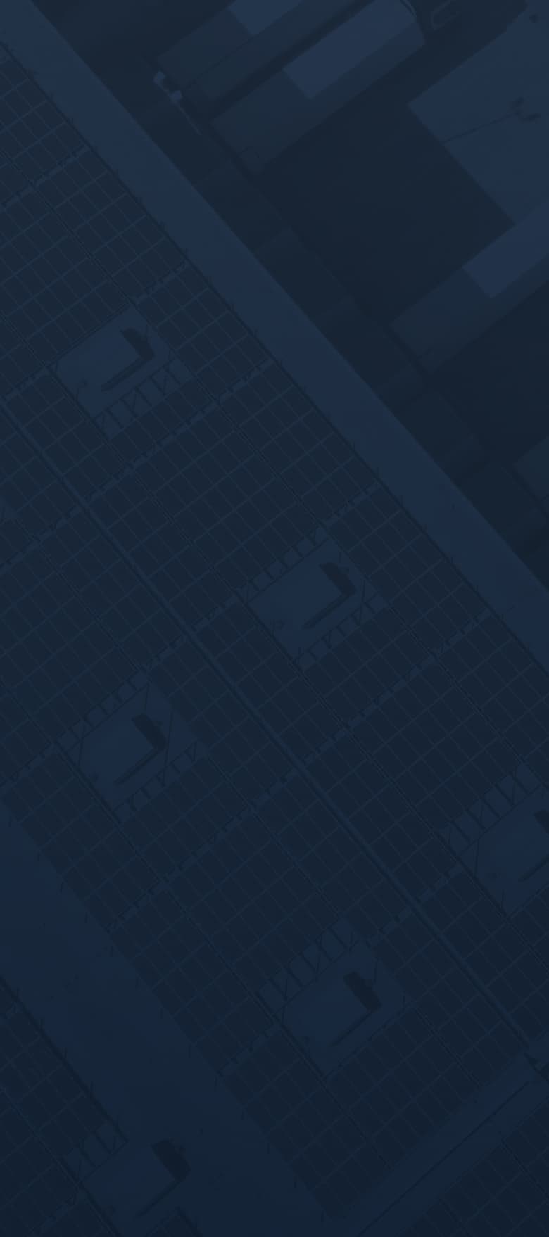 A grid-like overhead view of warehouses with solar panels